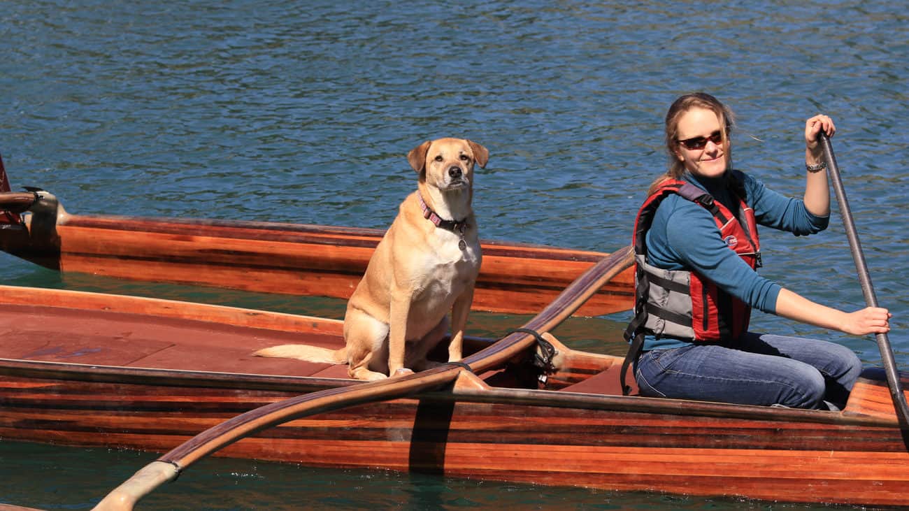 Dog and woman on a canoe